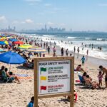NYC beach warning sign showing swimming advisory near the shoreline